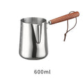 Garland stainless steel coffee milk jug with wooden handle, showing interior volume scale markings.