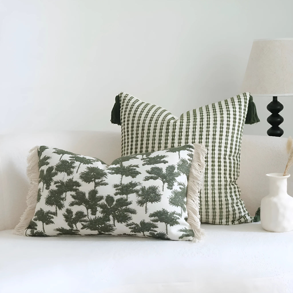 Green cotton and linen tassel hotel sample pillow with botanical patterns on a brushed fabric case
