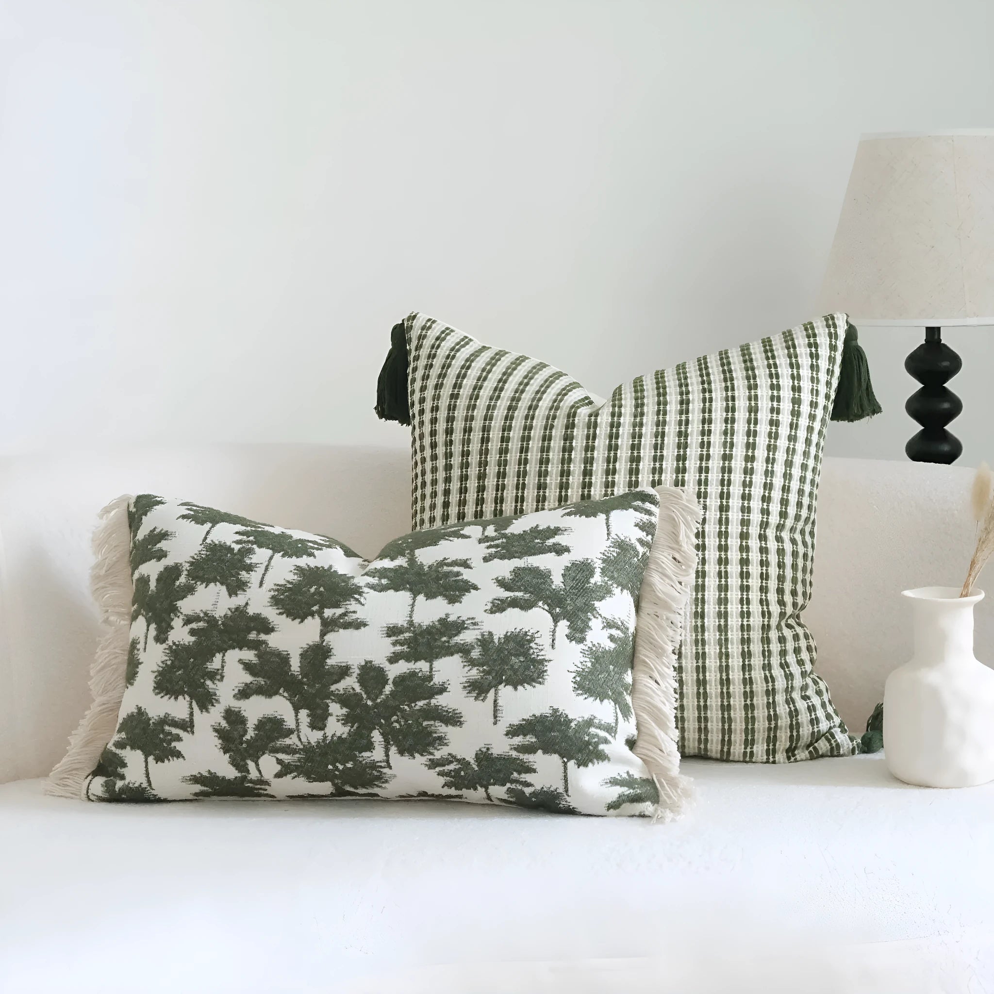 Green cotton and linen tassel hotel sample pillow with botanical patterns on a brushed fabric case