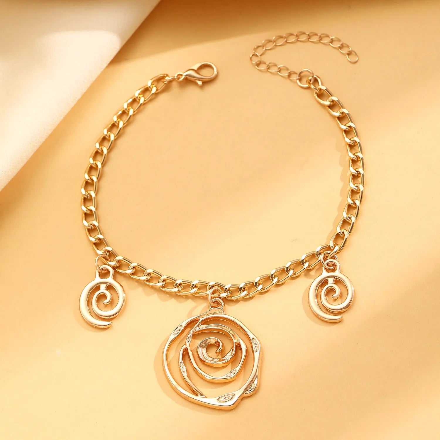 Geometric spiral donut jewellery set with necklace, bracelet, and earrings on adjustable 41-50cm chain