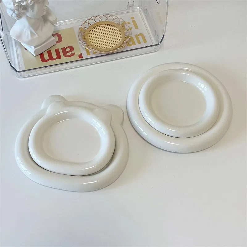 White ceramic plate with doodle design showing bear pattern, suitable for microwave use