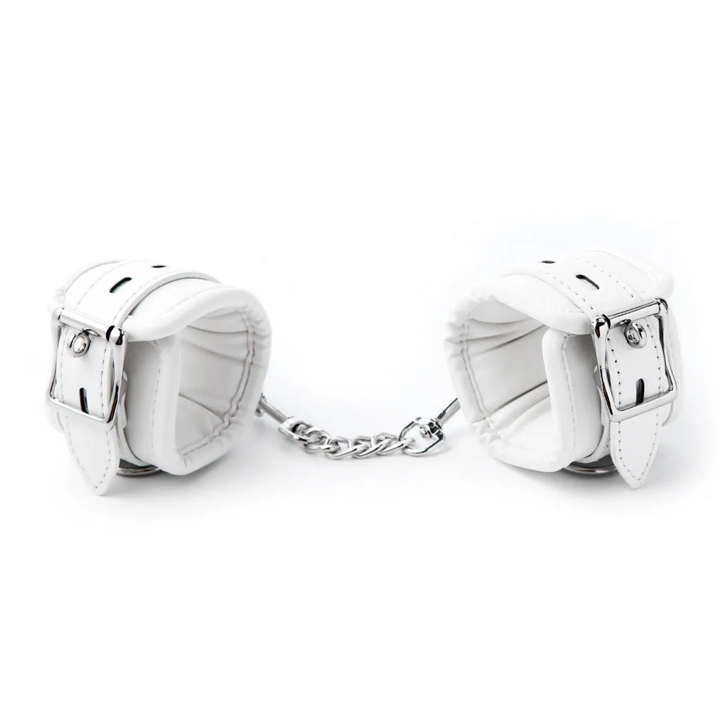 White PU sponge bondage restraint set showing handcuffs, footcuffs and neck scarf