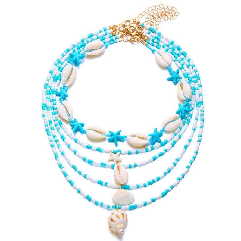 Five-piece women's necklace set with blue electroplated starfish, shell, and conch bead pendants on adjustable alloy chains.
