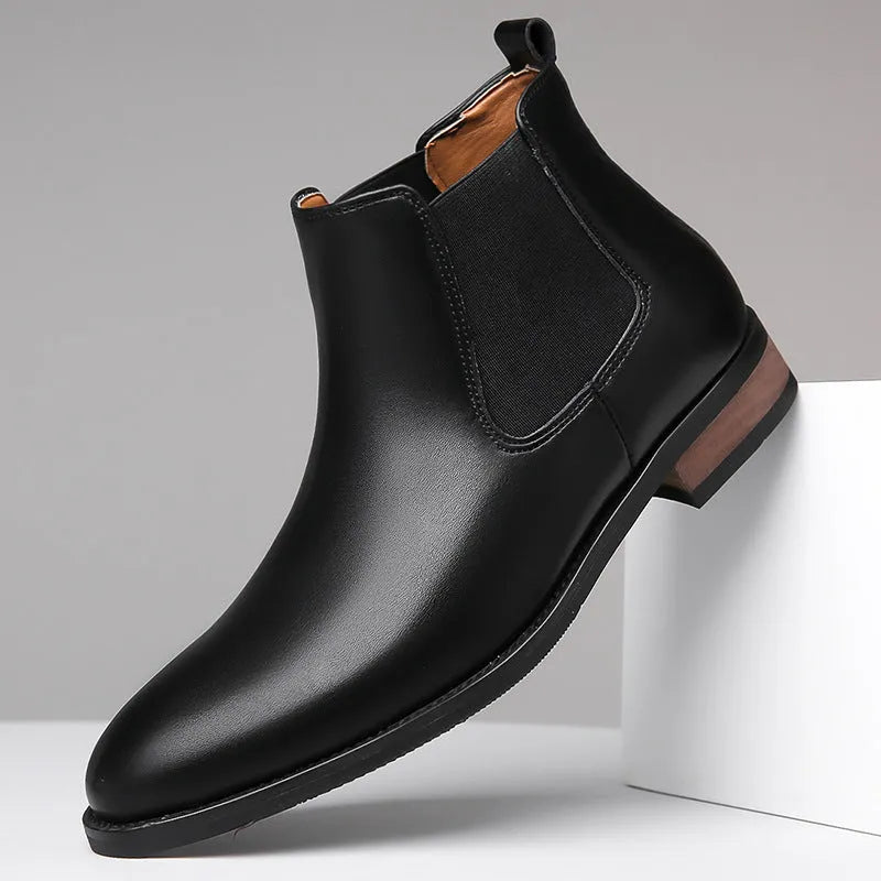 Men's black pointed toe Chelsea boots with artificial PU leather upper and decorative stitching