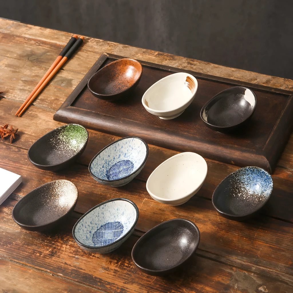 Oval Japanese ceramic sauce dipping bowl with underglaze finish on a table.
