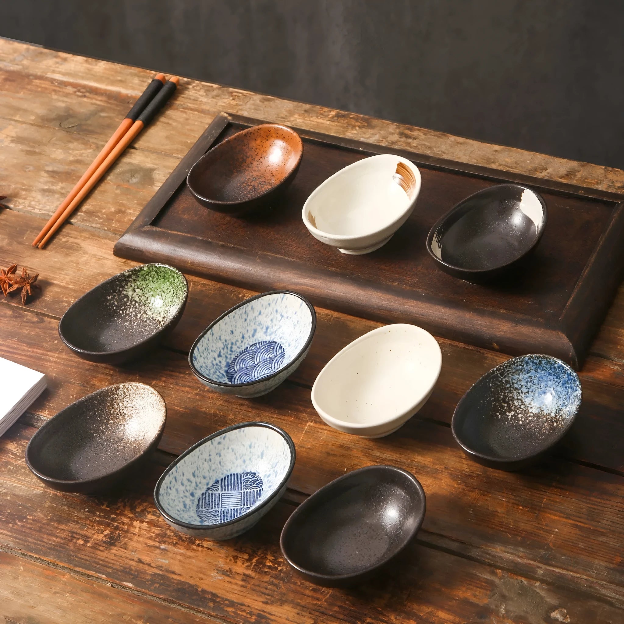 Oval Japanese ceramic sauce dipping bowl with underglaze finish on a table.