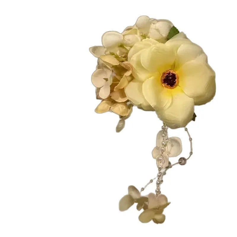 Women's floral tassel hair accessory with side clip in purple or yellow colour options