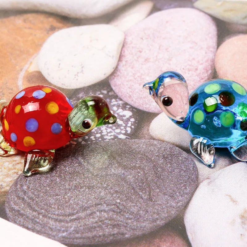 Geometric glass turtle sculpture ornament in a modern style on a wooden desktop.