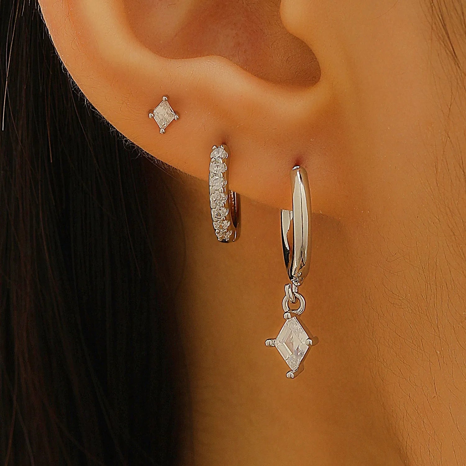 Three-piece geometric earrings set with inlaid zircon detailing on copper in gold and white colours