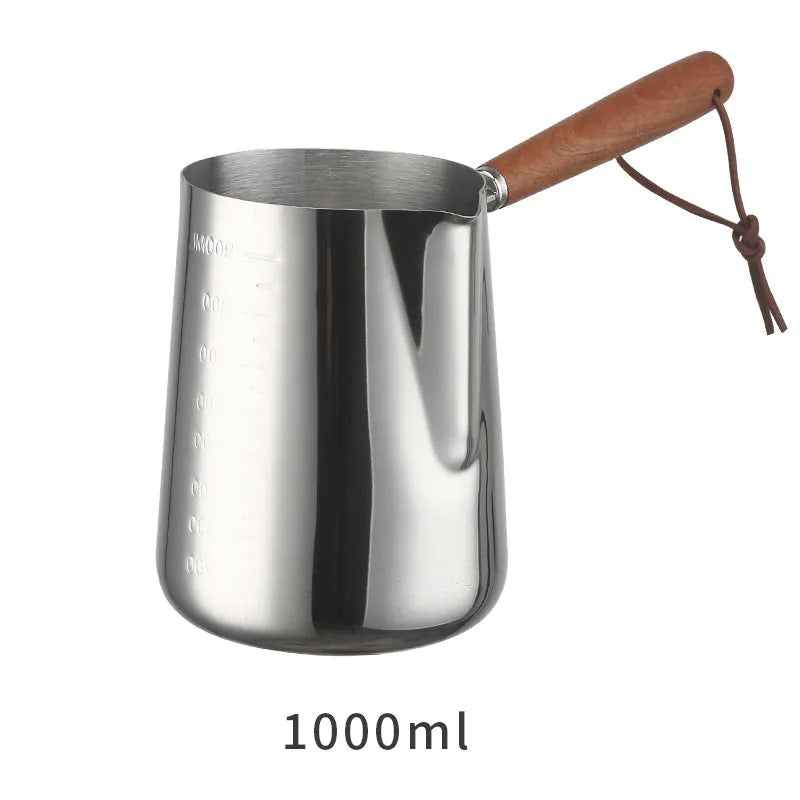 Garland stainless steel coffee milk jug with wooden handle, showing interior volume scale markings.