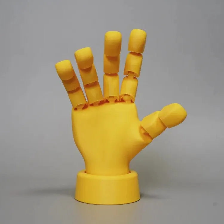 Yellow 3D printed hand ornament with movable joints and detailed sculpting