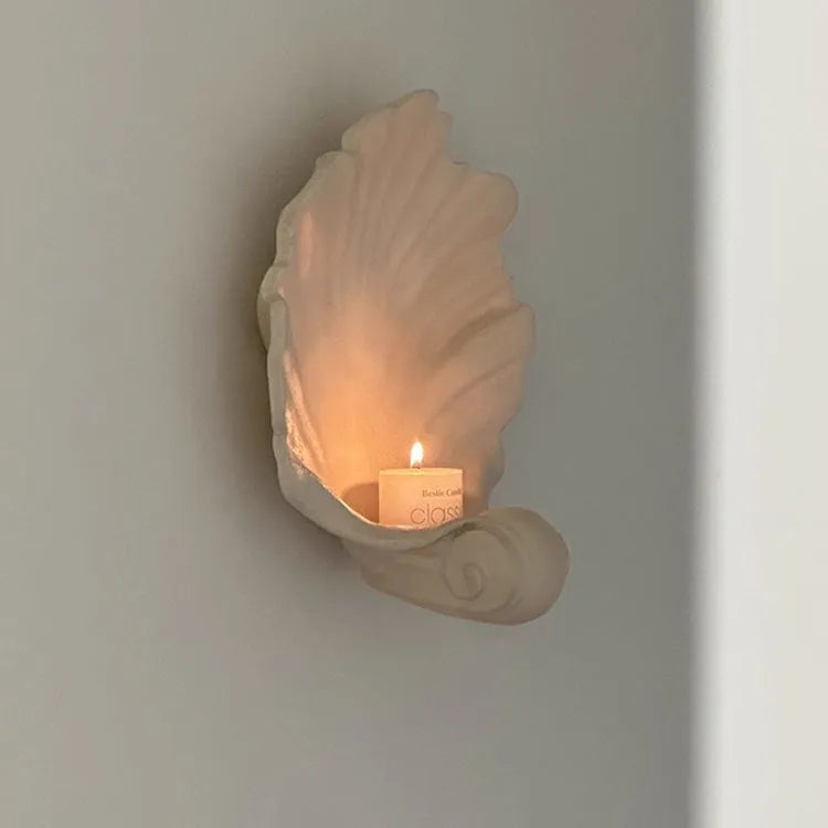 White resin shell-shaped fruit plate ornament on table setting