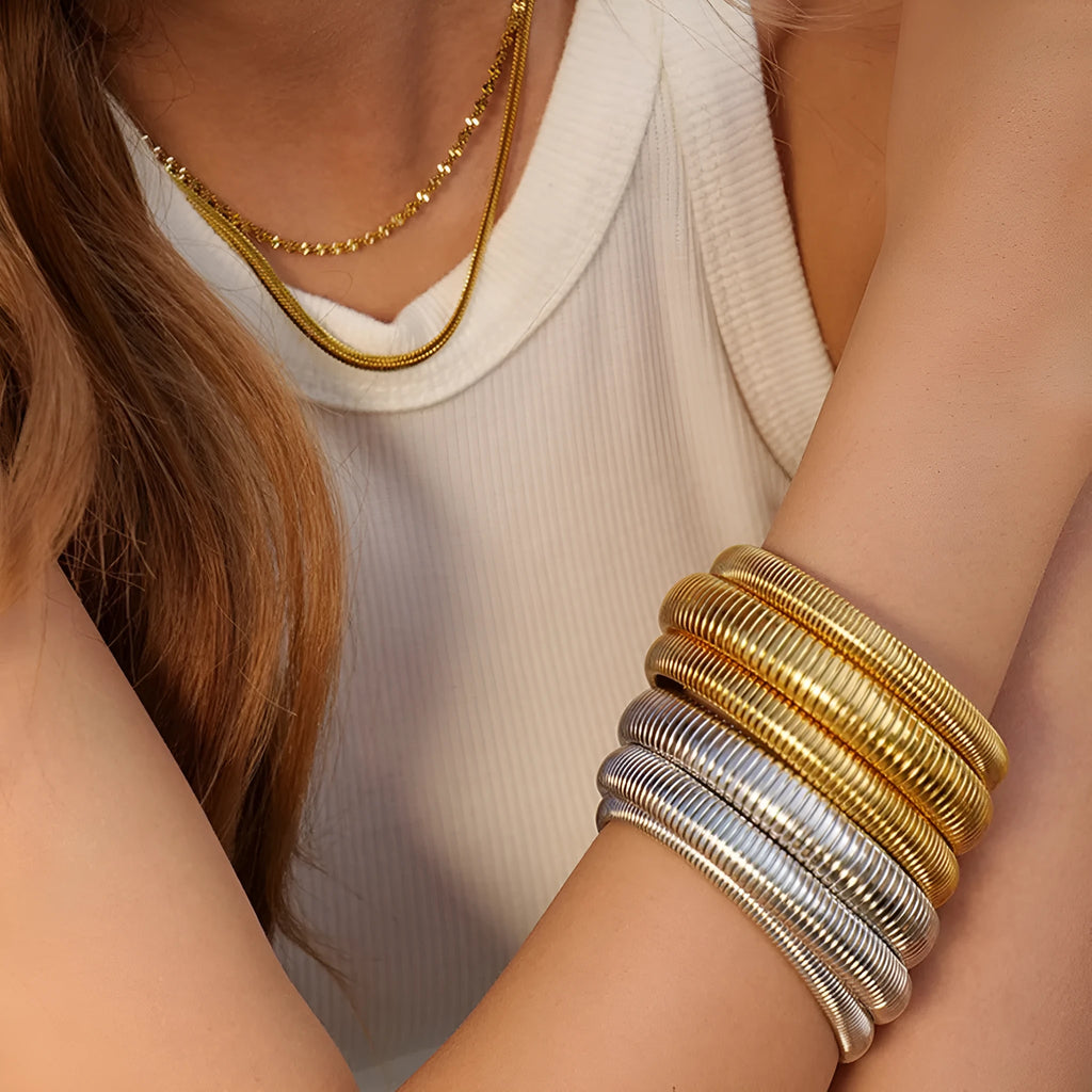 Gold titanium steel bracelet with elastic vertical stripe ring design, shown at 2cm width.