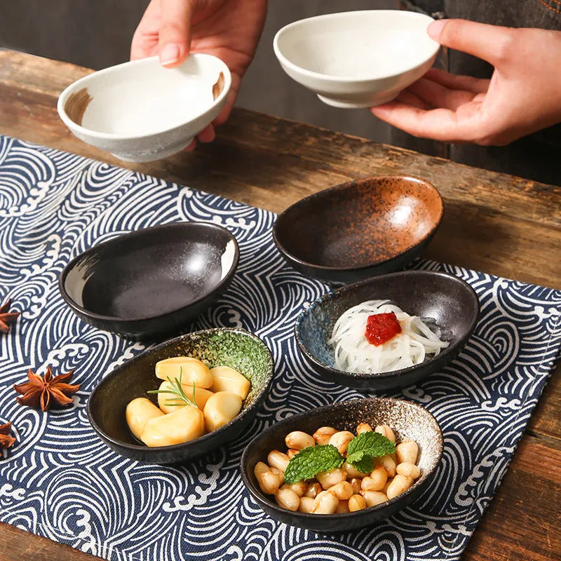 Oval Japanese ceramic sauce dipping bowl with underglaze finish on a table.