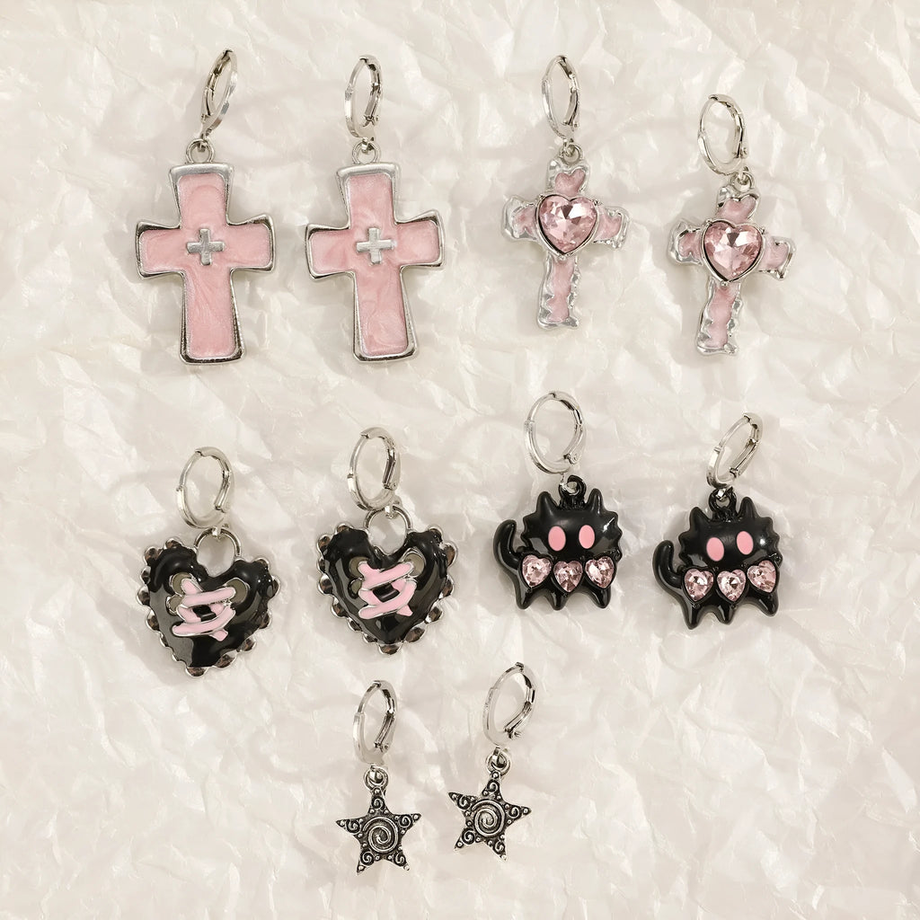 Women's alloy drop earrings featuring cross, heart, and cat charms in white, black, and antique silver finishes.