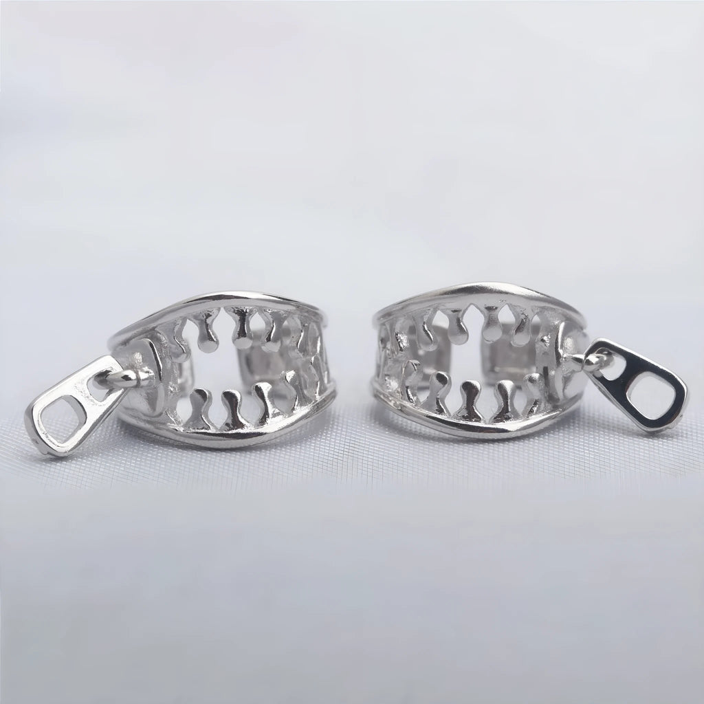 A pair of geometric copper clip-on earrings with a zip pull detail, in colour ES862, showing the bone clip fastening.