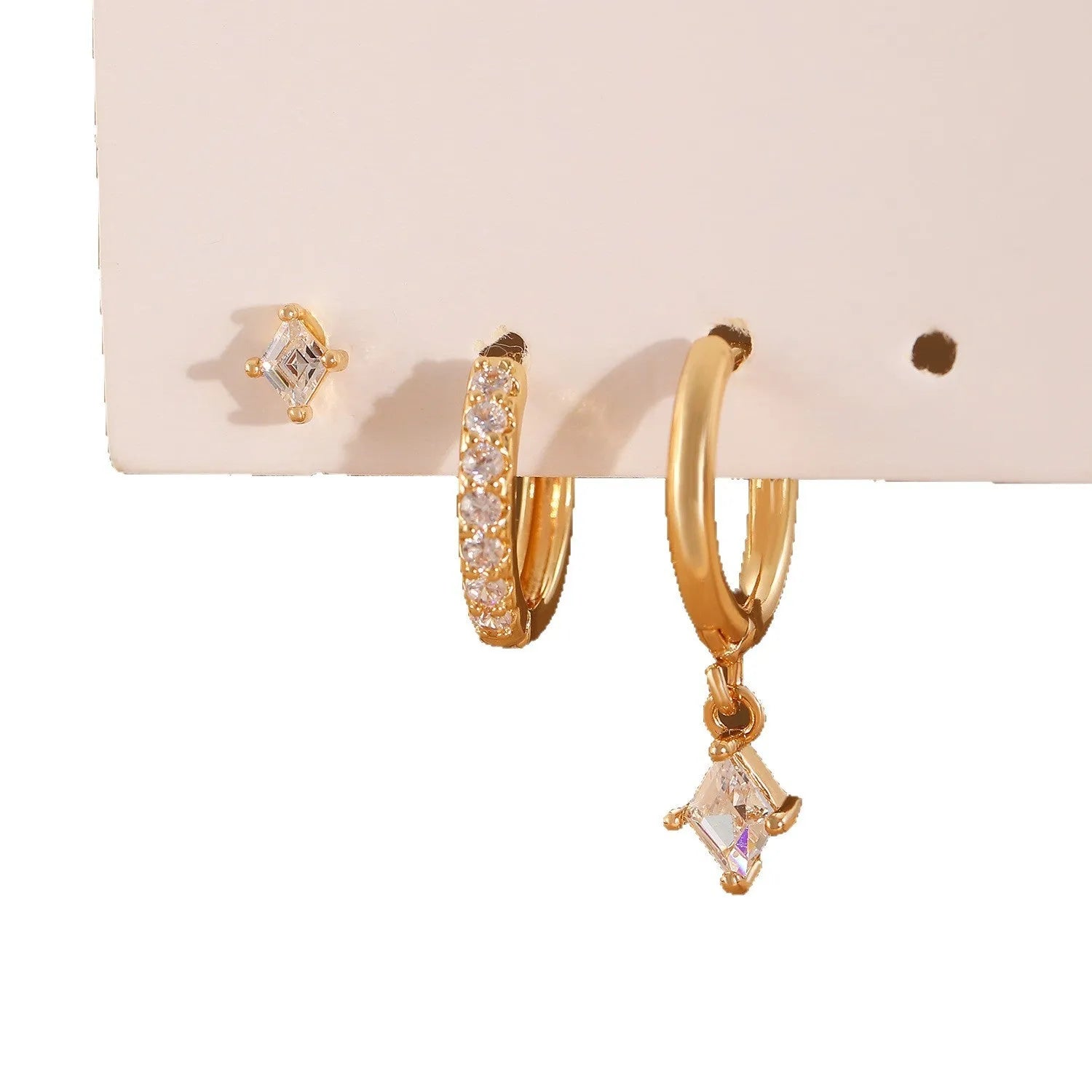 Three-piece geometric earrings set with inlaid zircon detailing on copper in gold and white colours