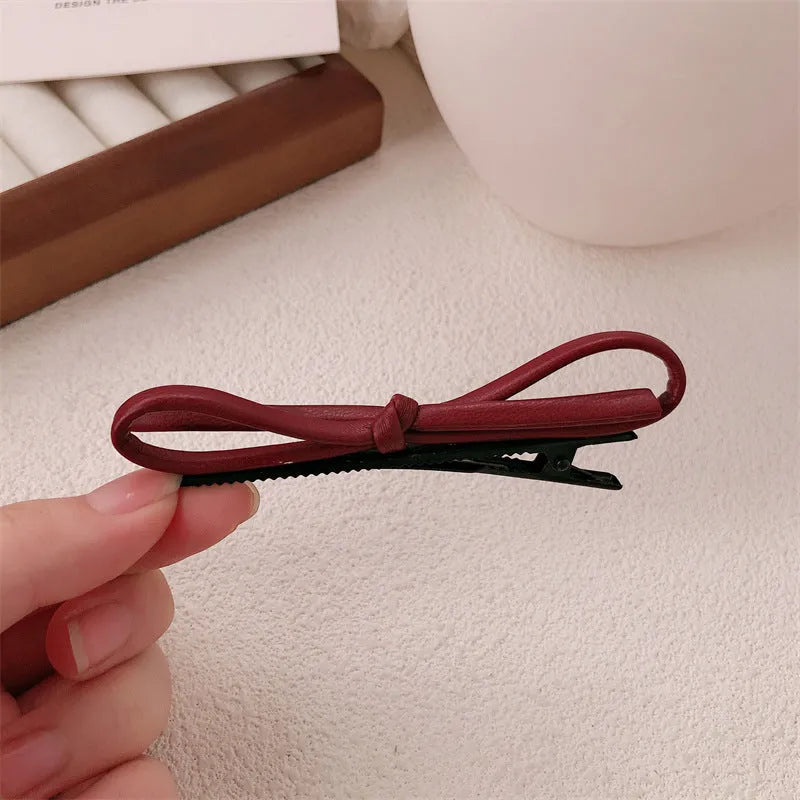 Wine red leather bow hair clip barrette showing advanced bow design and clip mechanism