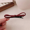 Wine red leather bow hair clip barrette showing advanced bow design and clip mechanism
