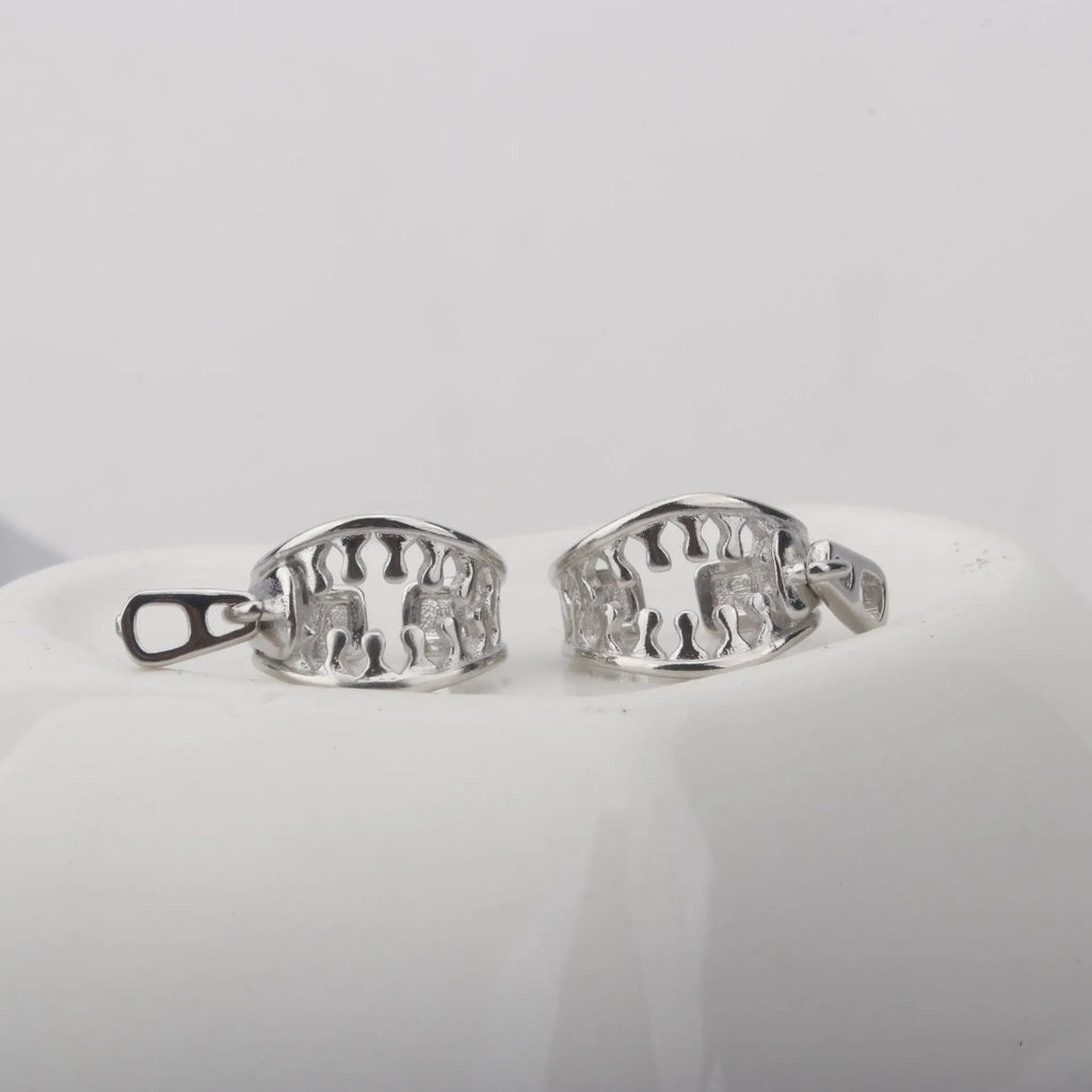 A pair of geometric copper clip-on earrings with a zip pull detail, in colour ES862, showing the bone clip fastening.