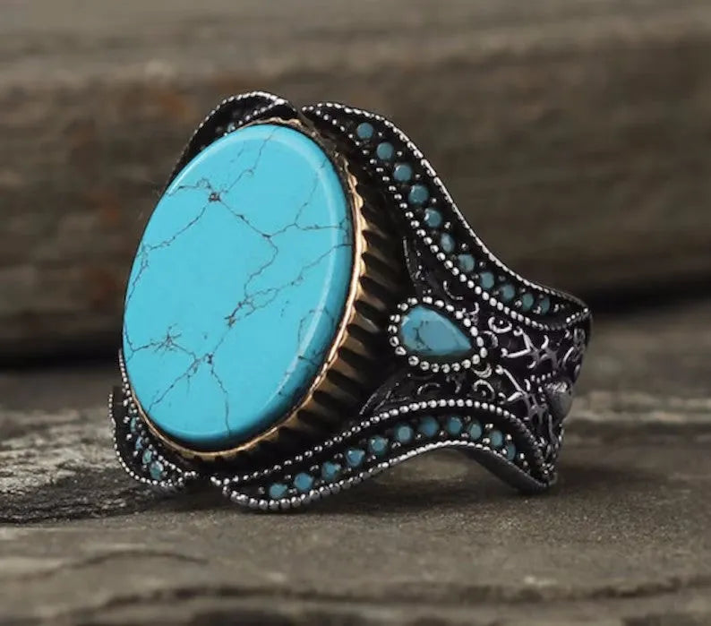 Men's antique silver alloy ring with turquoise accent on finger, showing round shape and simple design