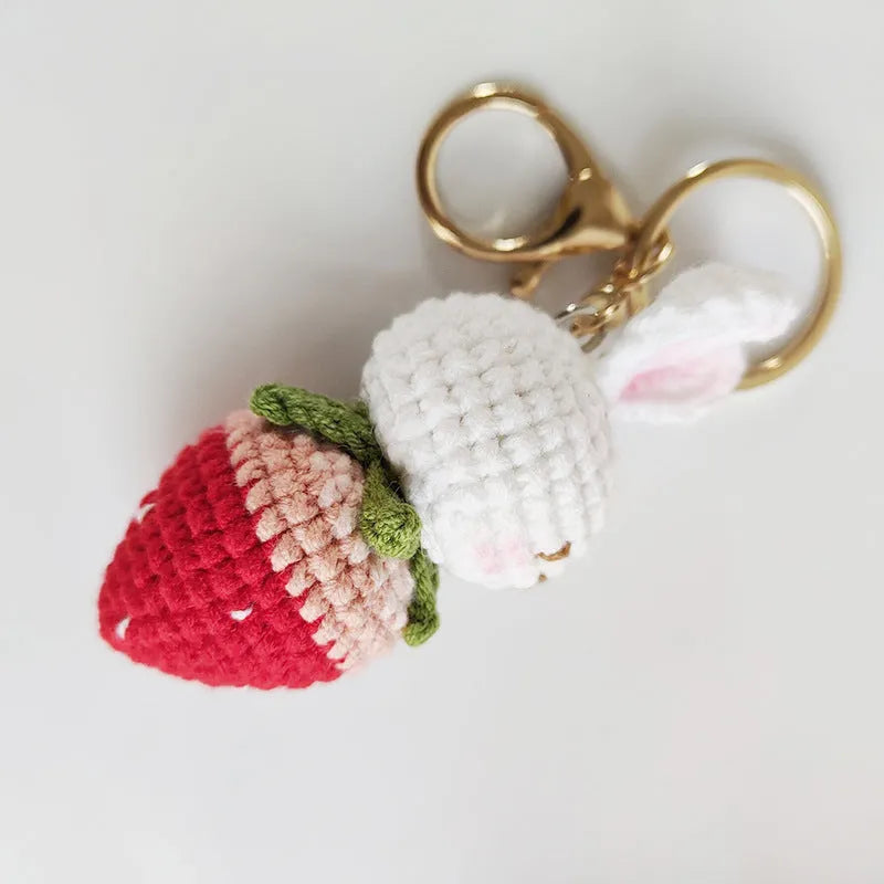 Hand-woven white wire pendant with rabbit and strawberry cartoon design and attached key