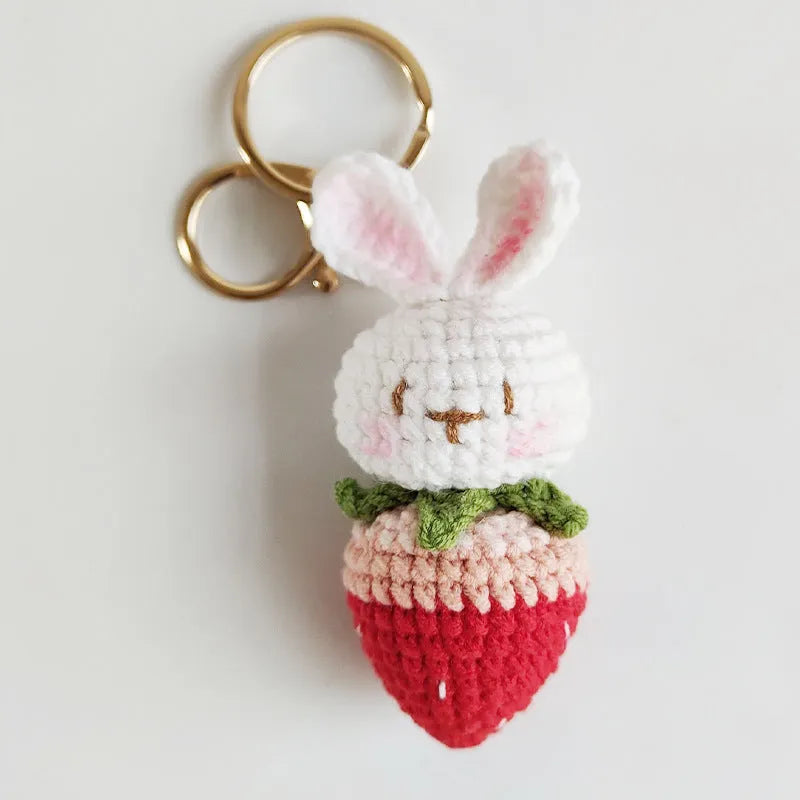 Hand-woven white wire pendant with rabbit and strawberry cartoon design and attached key