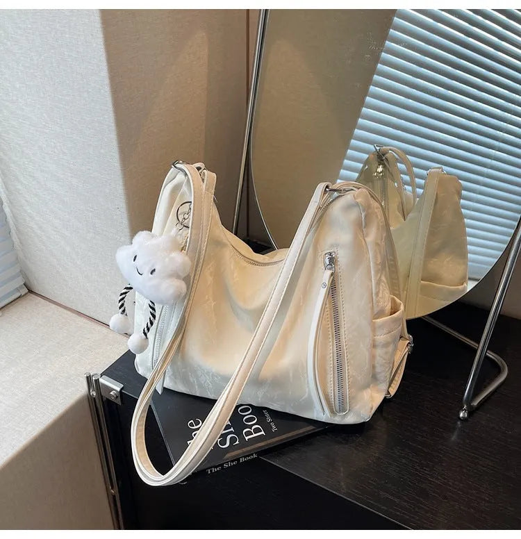 Women's soft PU fashion backpack in black with pendant accessory
