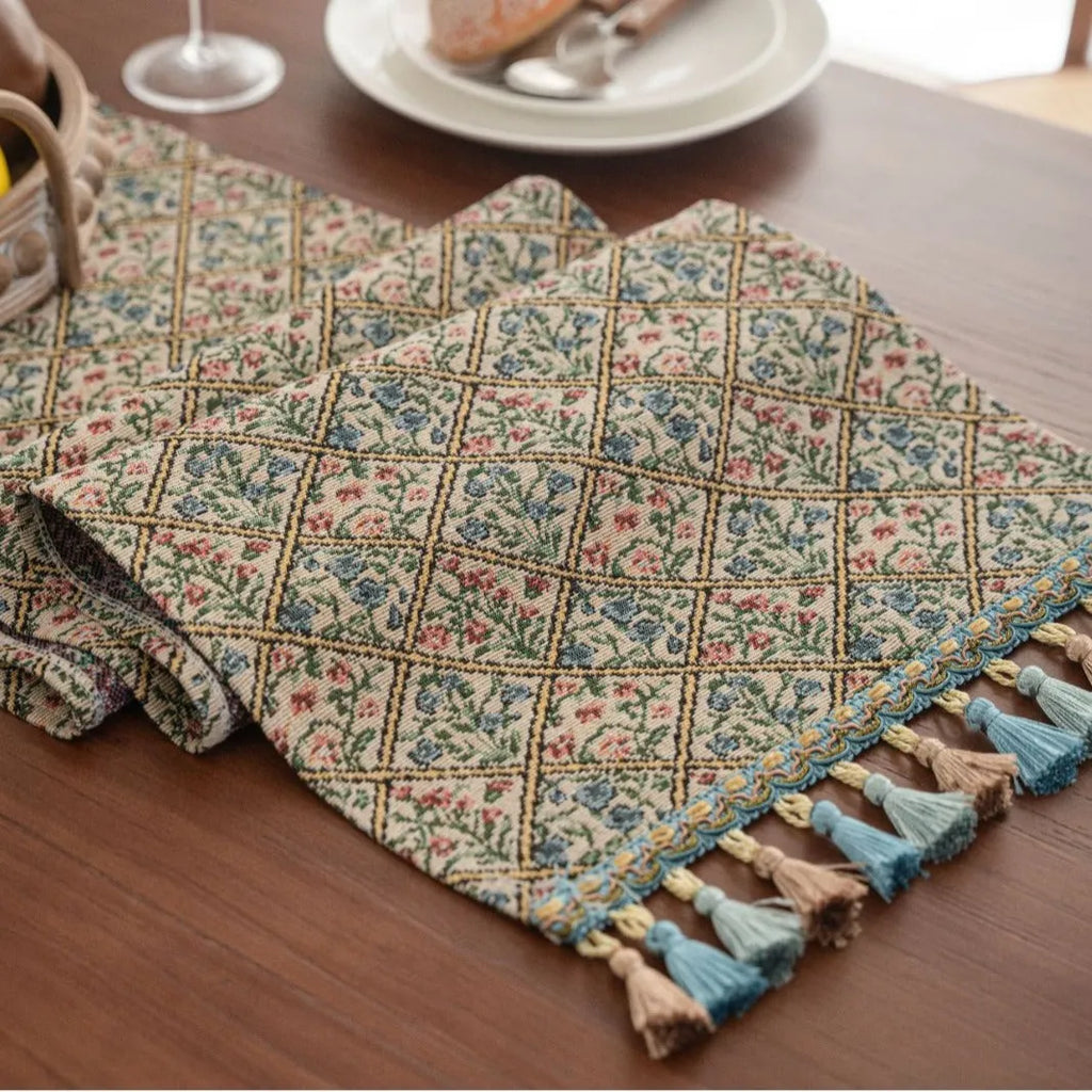 Dark blue Nordic jacquard table runner with bouquet pattern and tassel fringe on wooden table