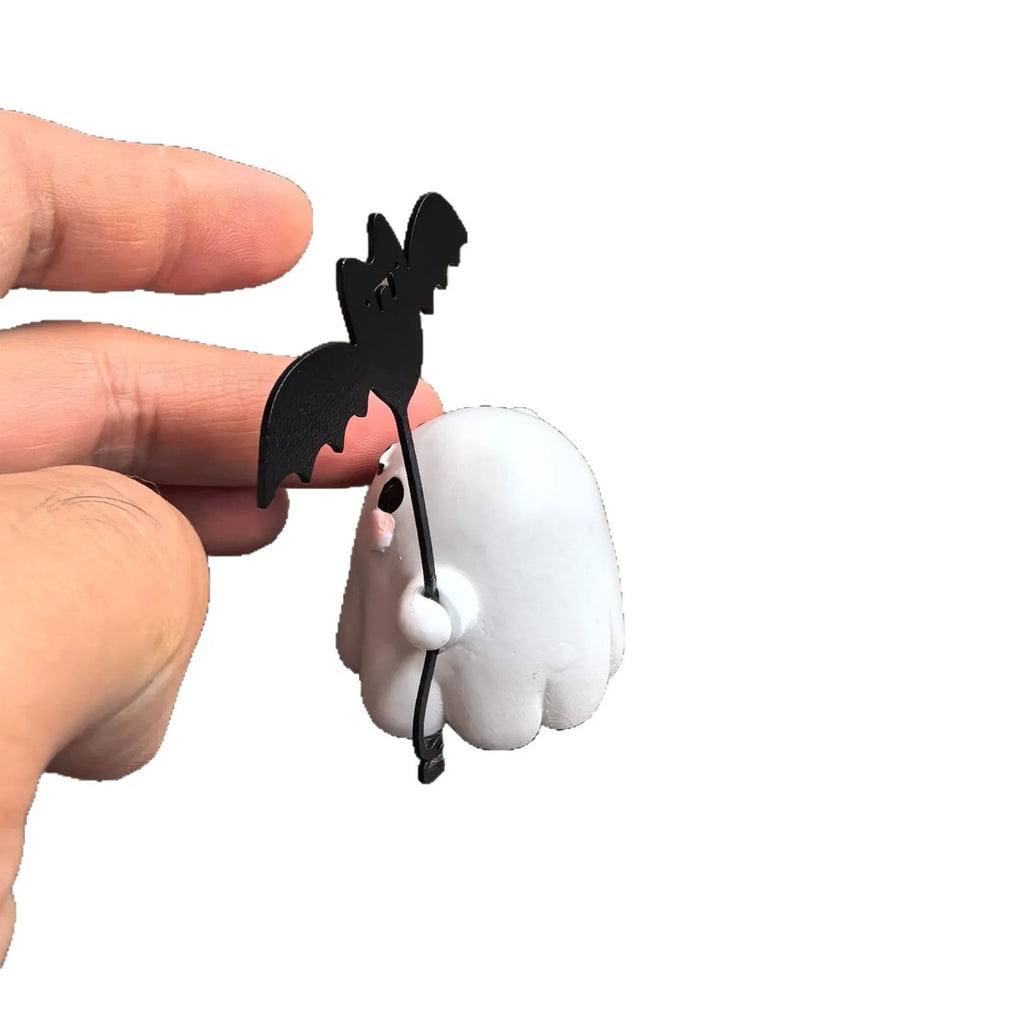 Mini ghost walking dog Halloween statue holding a bat, resin figurine on white background.