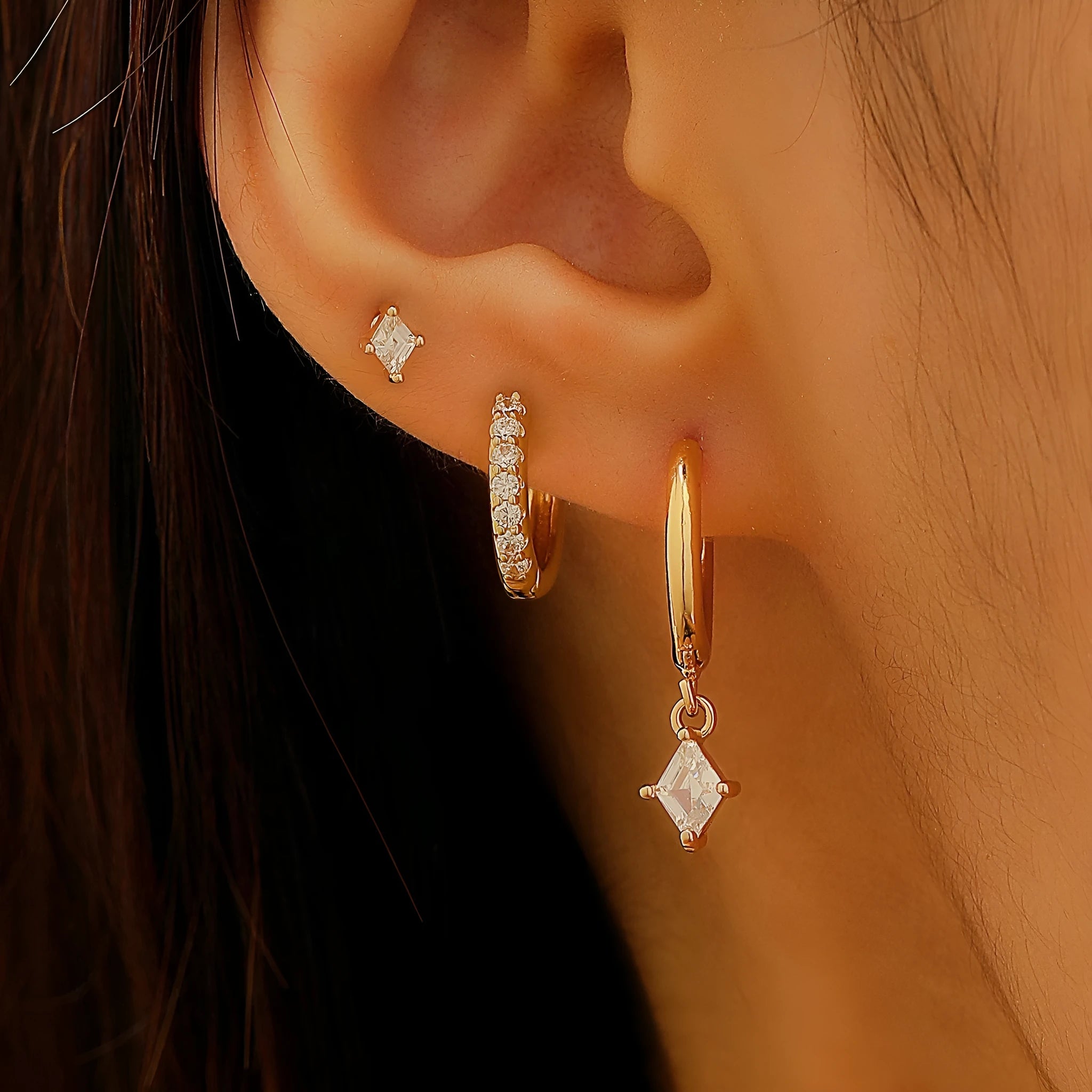 Three-piece geometric earrings set with inlaid zircon detailing on copper in gold and white colours