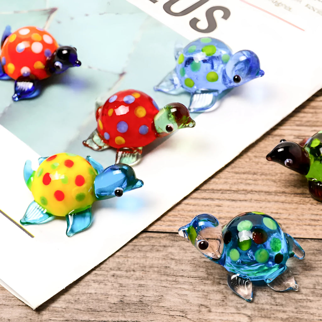 Geometric glass turtle sculpture ornament in a modern style on a wooden desktop.