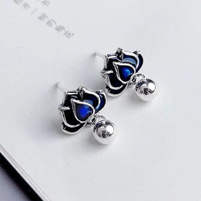 A pair of blue lotus flower alloy ear studs with a retro tassel design.