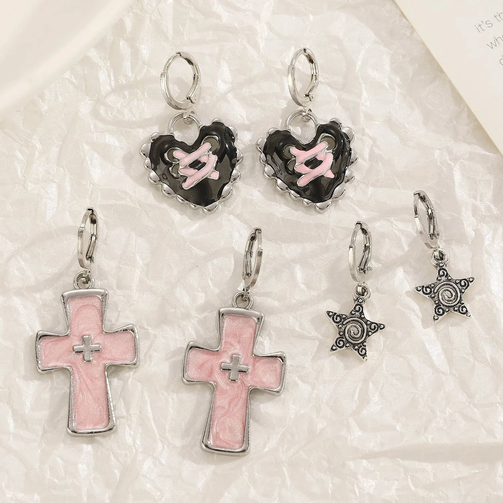 Women's alloy drop earrings featuring cross, heart, and cat charms in white, black, and antique silver finishes.