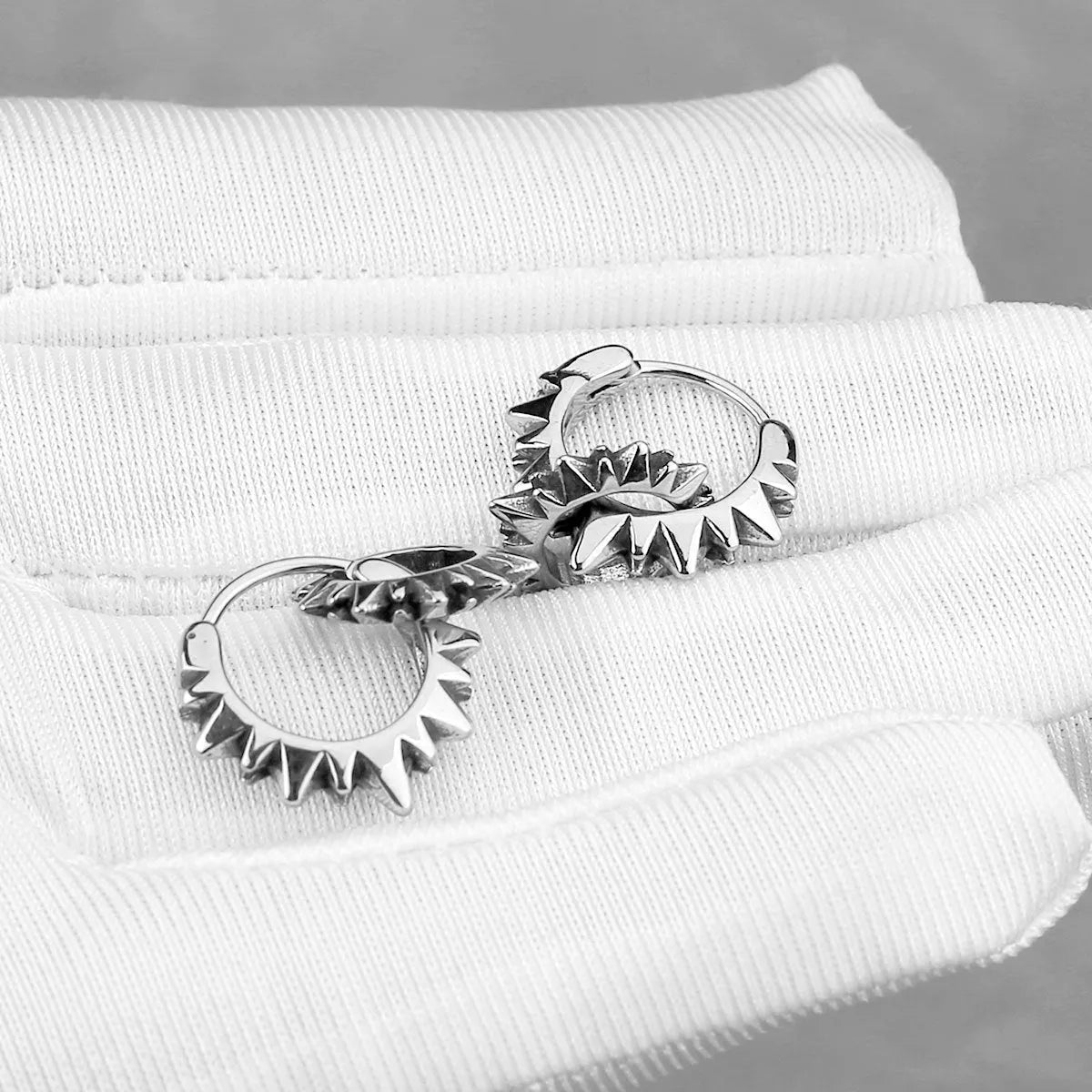 Stainless steel round ring earrings with polished steel finish and retro design