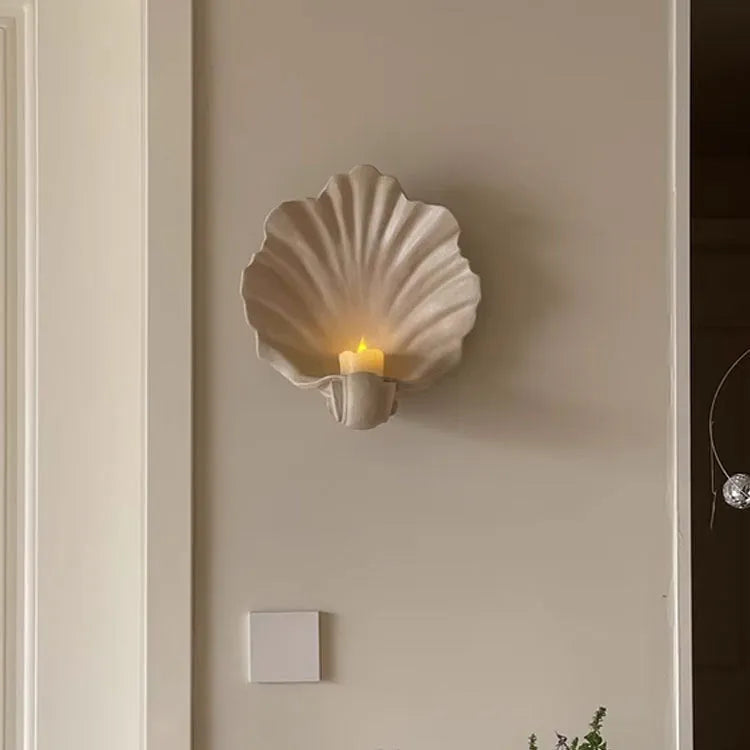 White resin shell-shaped fruit plate ornament on table setting