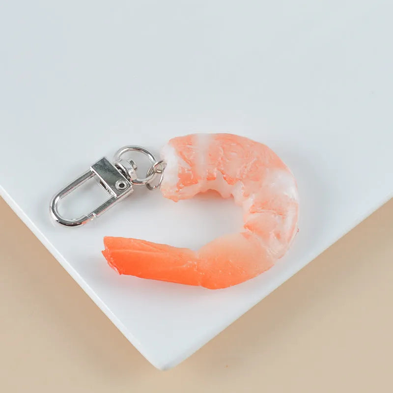 Detailed PVC simulation shrimp keychain bag charm on a white background.