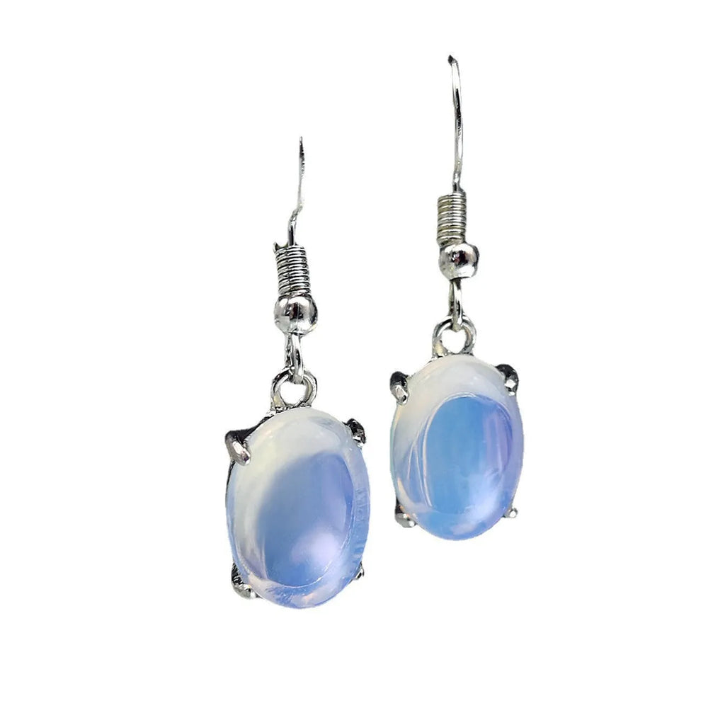 A pair of alloy drop earrings with a moonlight opal electroplated finish and a retro cross design within an ellipse shape.