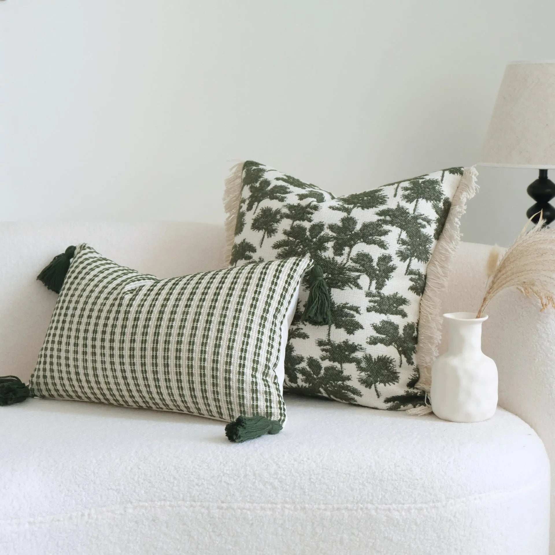 Green cotton and linen tassel hotel sample pillow with botanical patterns on a brushed fabric case