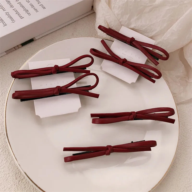 Wine red leather bow hair clip barrette showing advanced bow design and clip mechanism