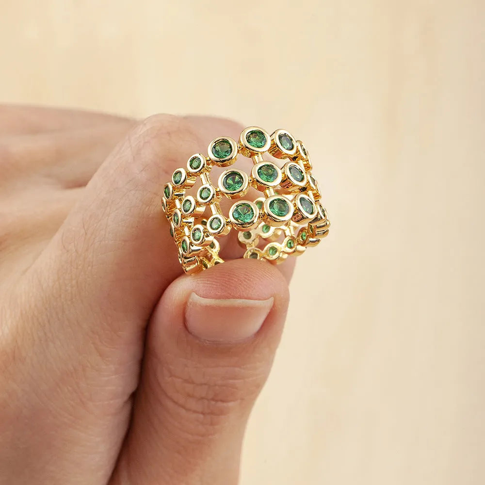 Gold coloured wide band ring with green zircon stones and three-layer copper plating