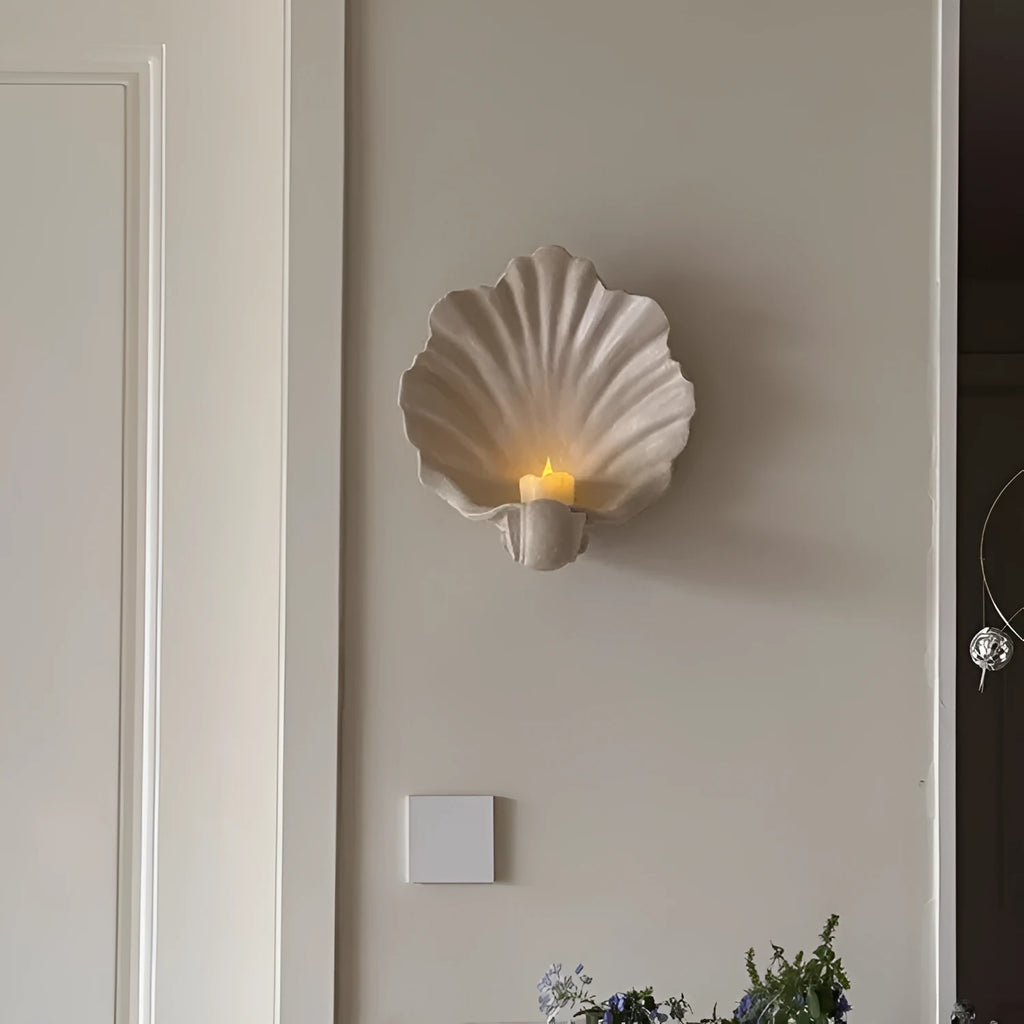 White resin shell-shaped fruit plate ornament on table setting