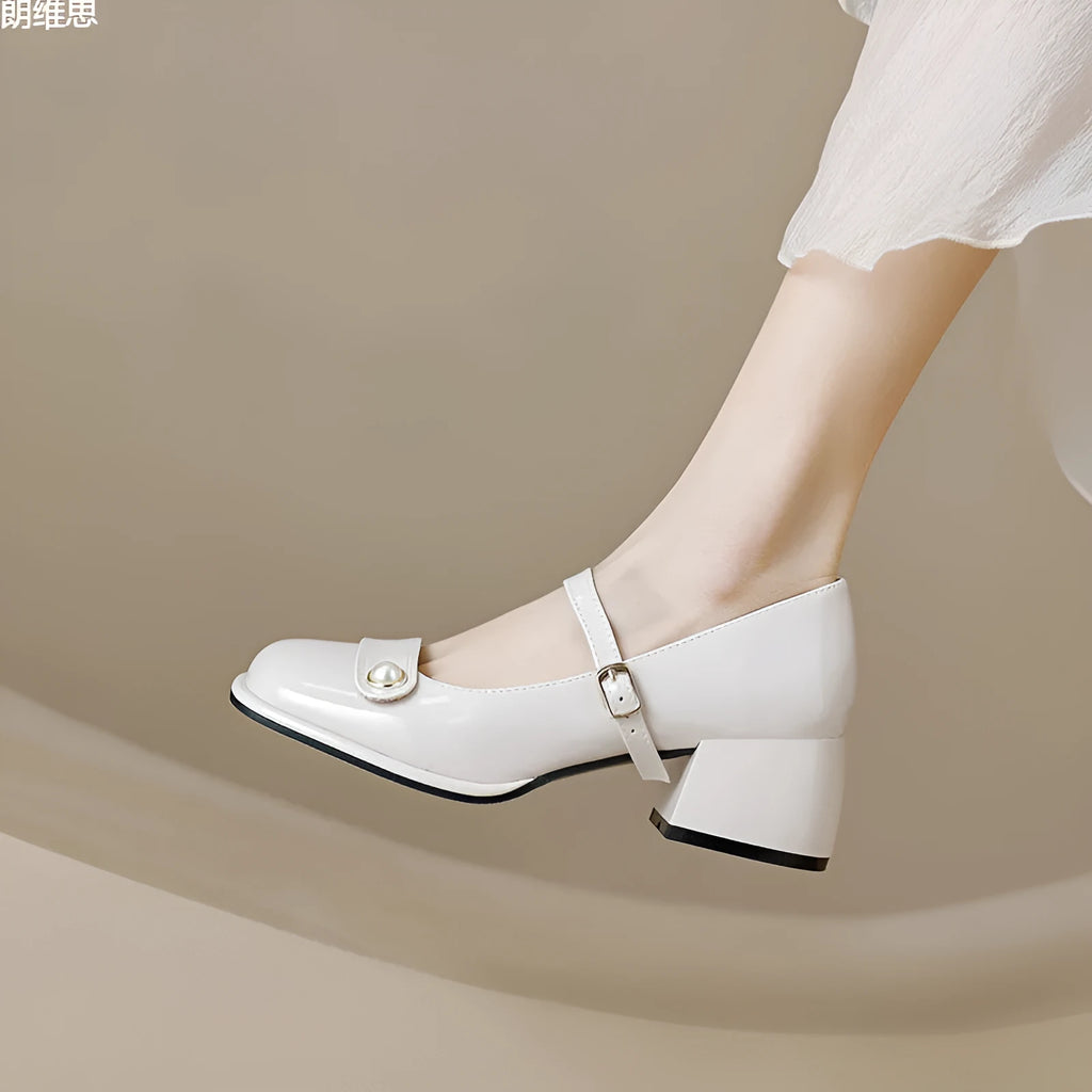 Plus size women's chunky heel pumps in patent leather with a square toe and front buckle, shown in apricot colour.