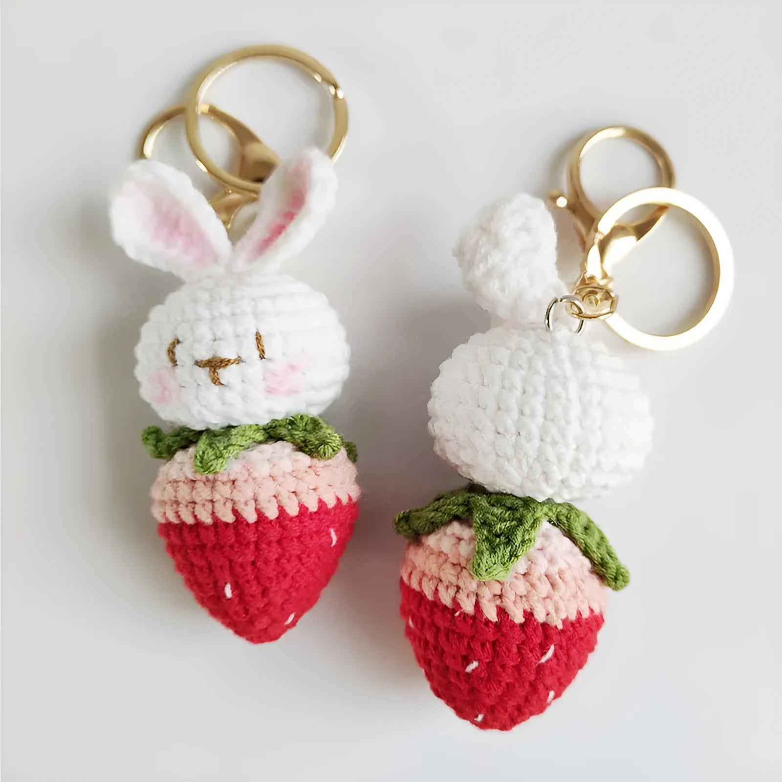 Hand-woven white wire pendant with rabbit and strawberry cartoon design and attached key