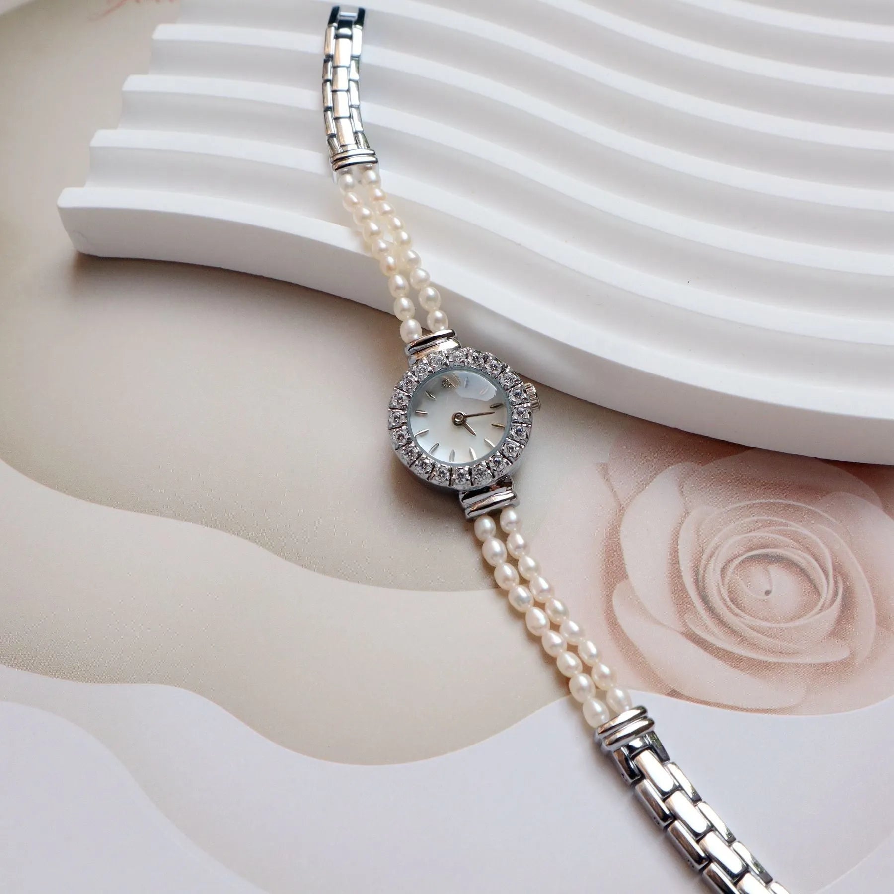 Women's light gold bracelet watch with freshwater pearls and round 18mm dial