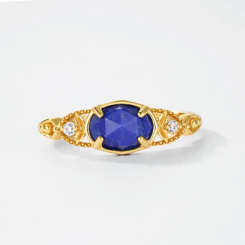 Women's ellipse geometric ring with round blue Lapis Lazuli stone on silver alloy band.