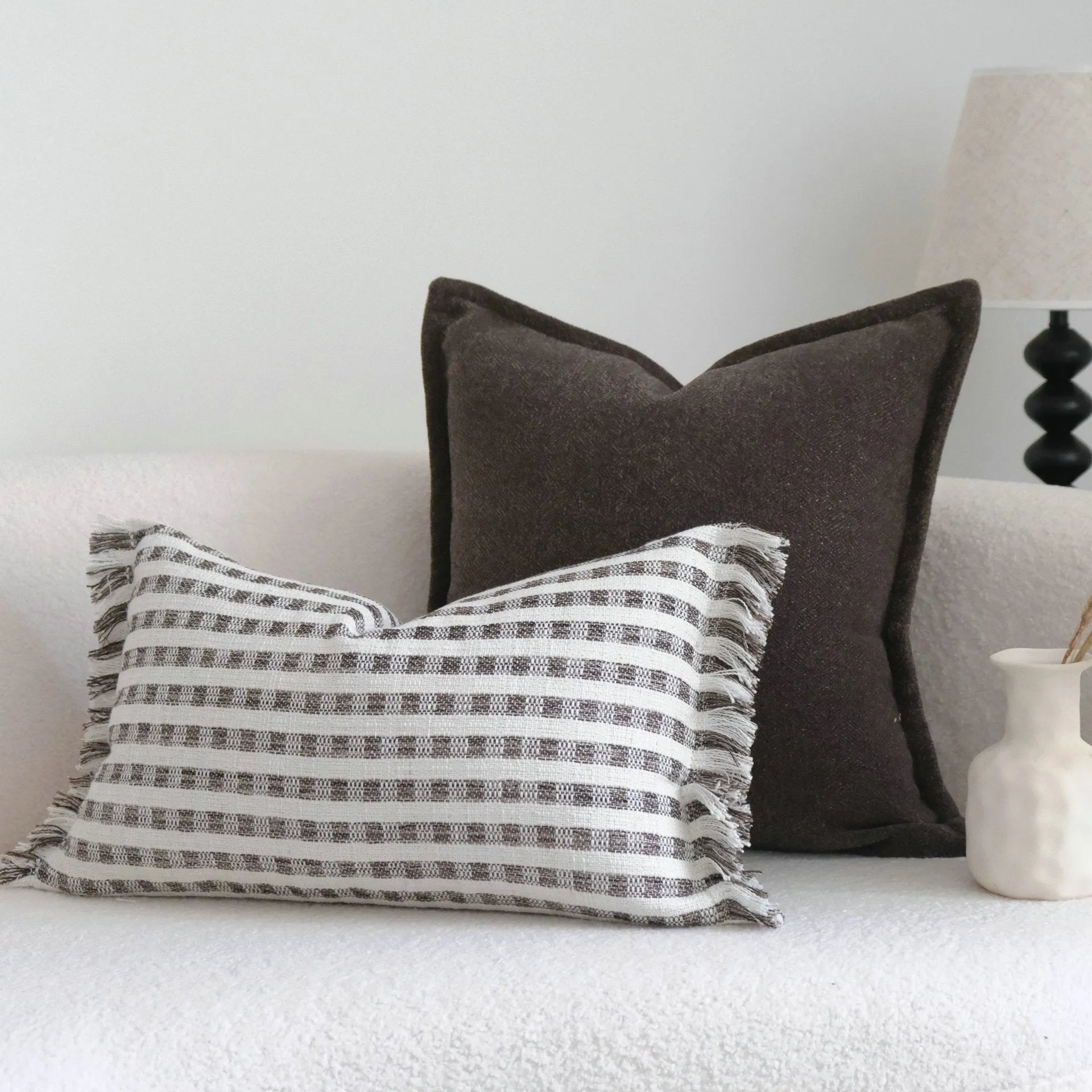 Coffee brown striped Chinese classical style pillow cushion on a sofa, shown in both square and waist pillow sizes.