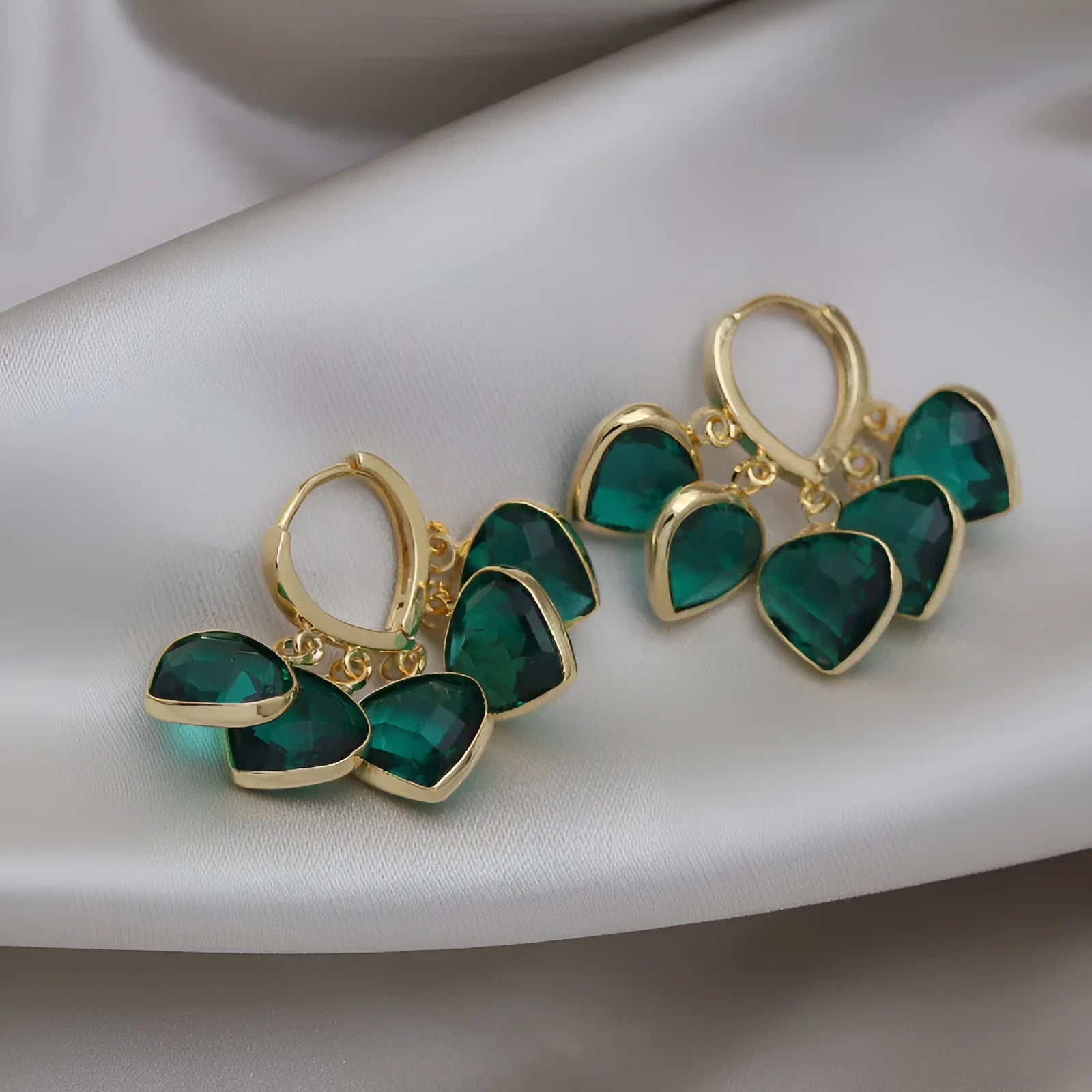 Green heart-shaped ear clip earrings with dancing shade design and artificial gemstones