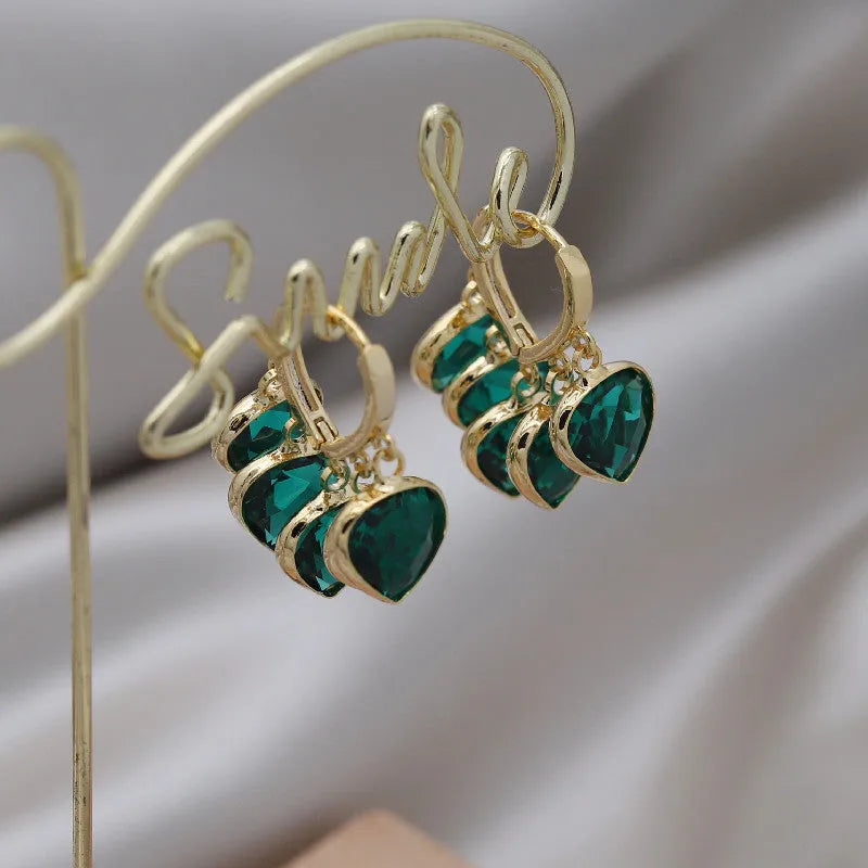 Green heart-shaped ear clip earrings with dancing shade design and artificial gemstones