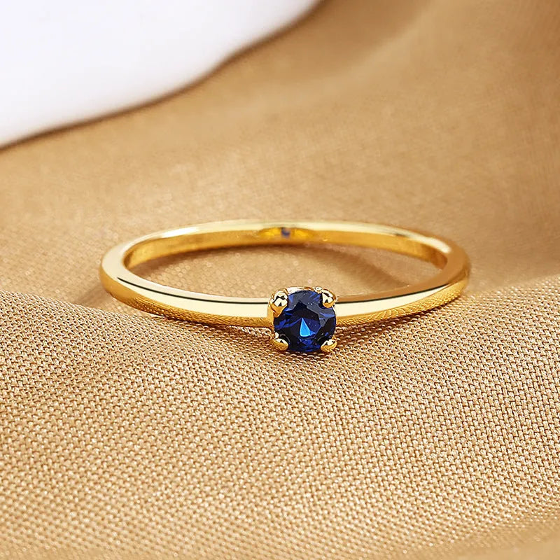 Copper geometric circle ring for women with a single diamond detail, shown in multiple colour options.